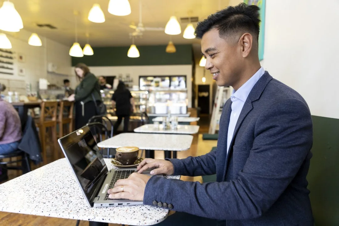 Image of a person working on a laptop