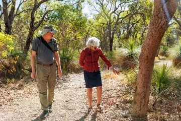 Mark Brundrett and Stephanie Murphy, Coordinator of Friends of Warwick Bushland, walking through Warwick Bushland. 