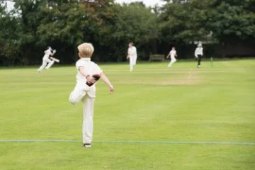 Youth player warming up for cricket game