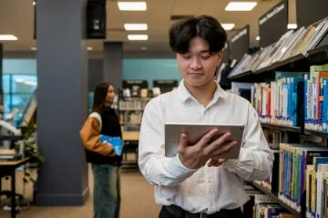 Photo of a person studying at a library