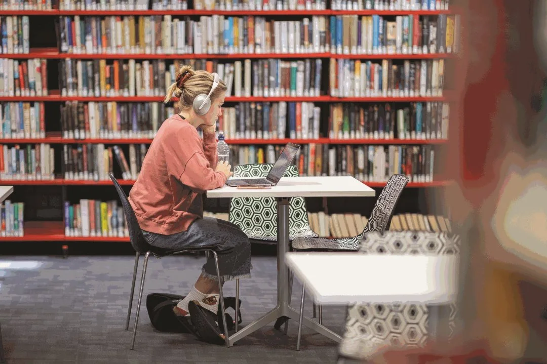 Photo of person enjoying library as study area