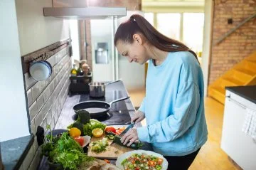 Adult woman preparing healthy salad