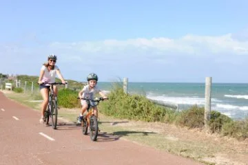 Photo of people riding bikes along the coast