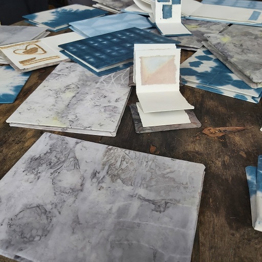 Paper, books and ink pad on a wooden desk