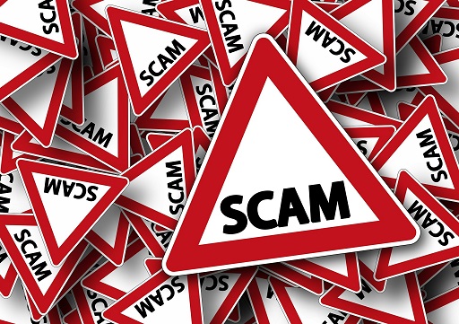 Triangle warning signs containing the word scam