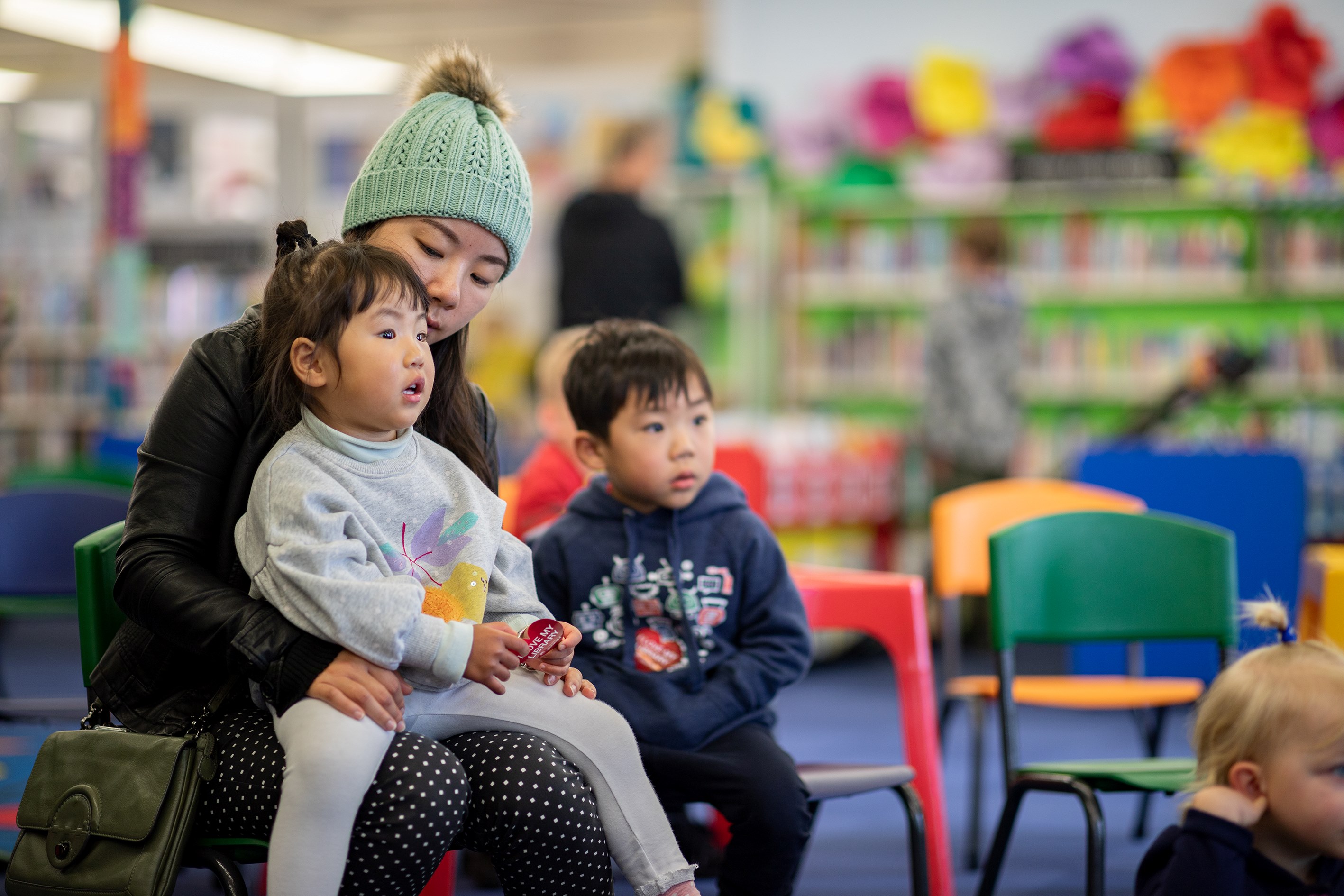 A mum with two young children enjoying a library event